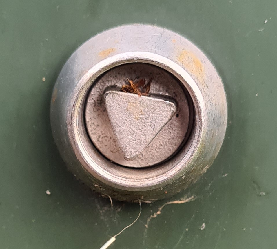 Close up photograph of a keyhole on an Openreach cabinet with a star-shaped insert